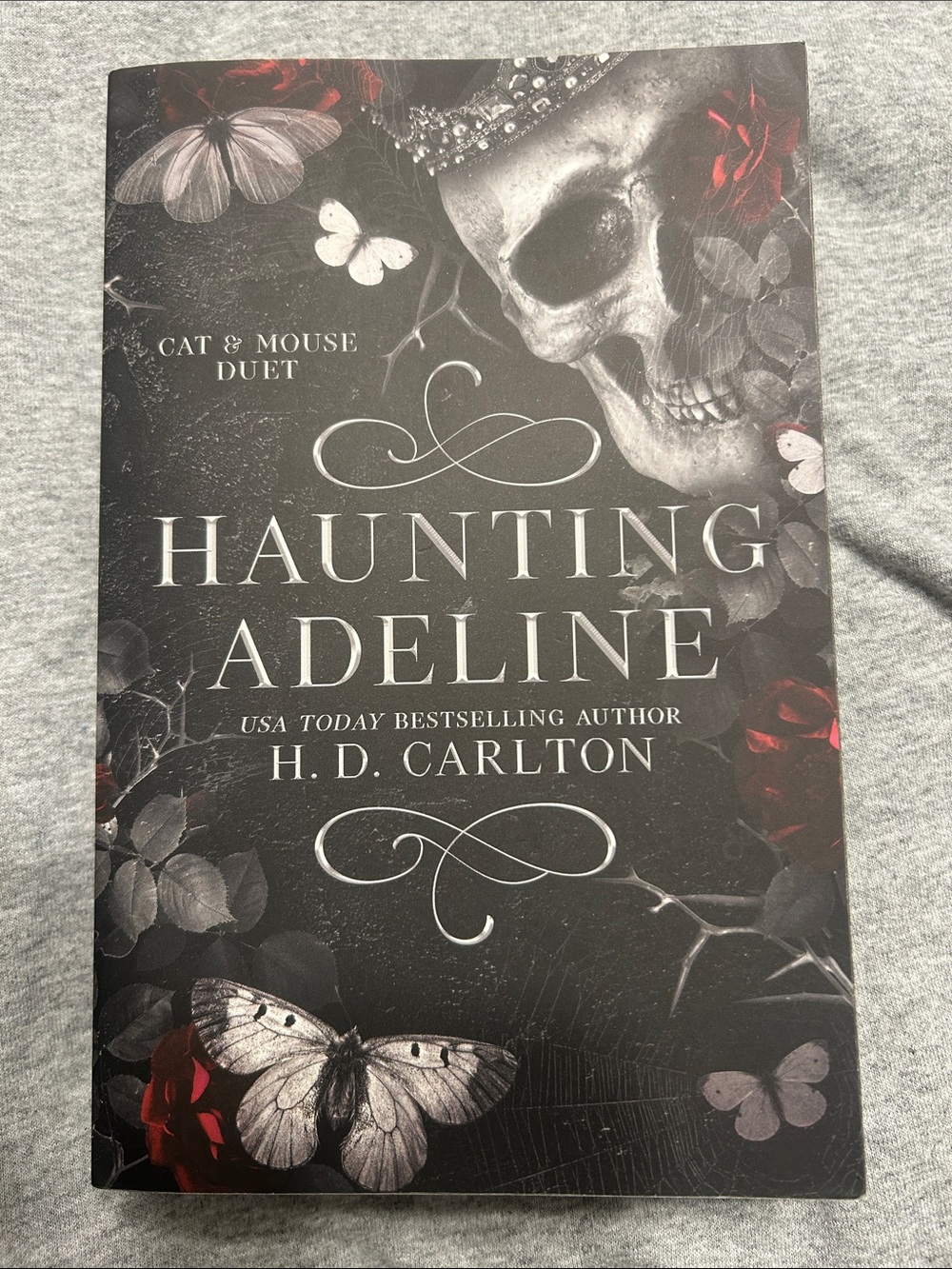Haunting Adeline by H. D. Carlton - Black and Red Book Cover